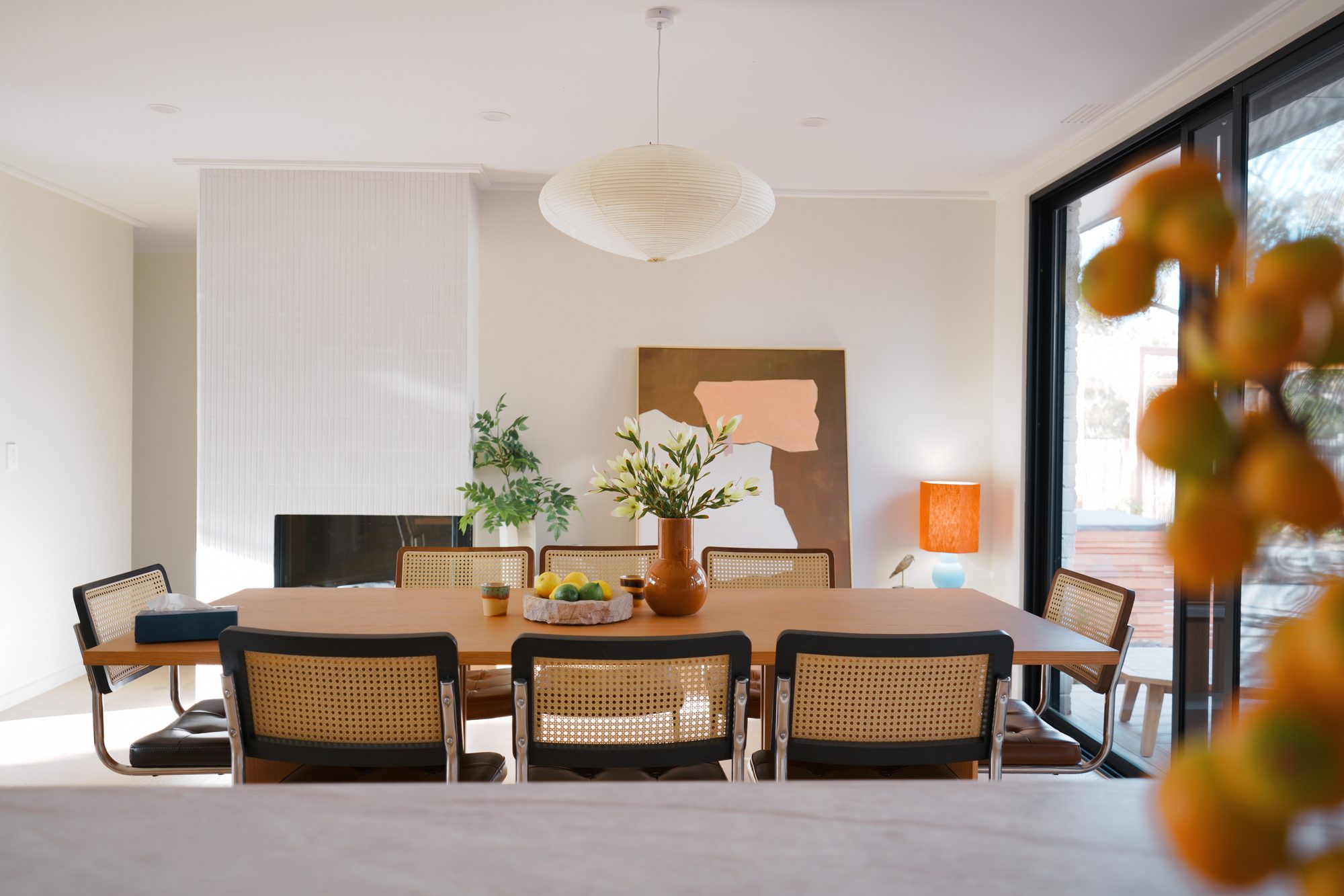 Finchwood House dining room — oak table, cane chairs and tiled fireplace